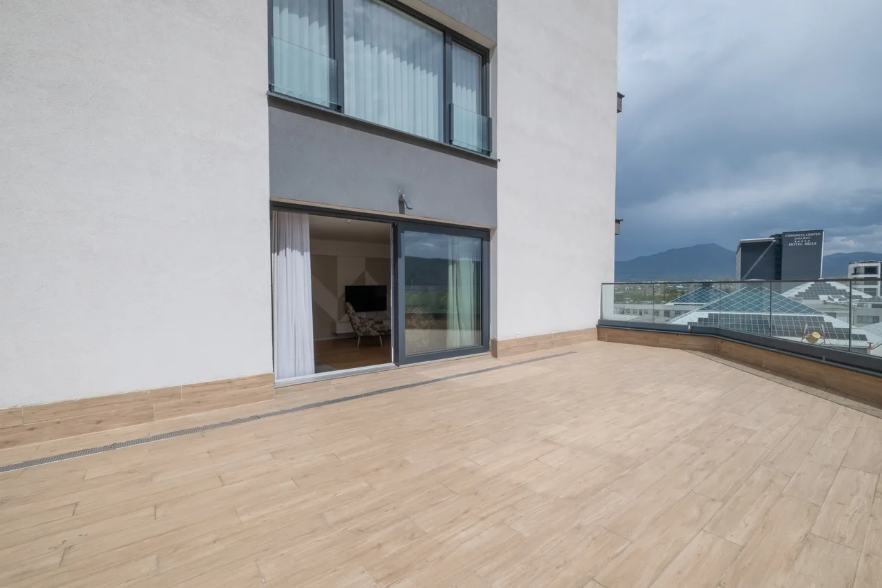 Outdoor space — Three-bedroom apartment. Cream kitchen and terrace